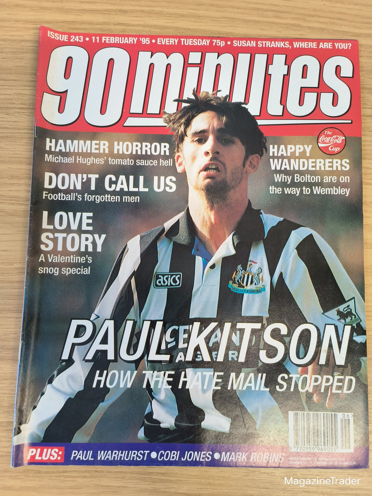 Magazine cover featuring a football player with text about hate mail on a wooden surface
