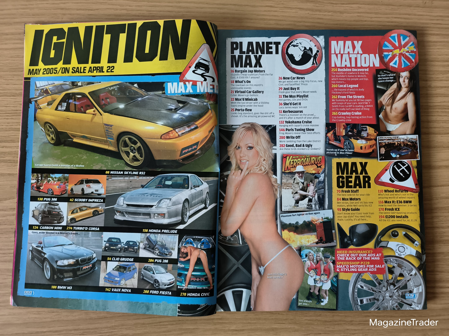 Open magazine with car-themed content on a wooden surface